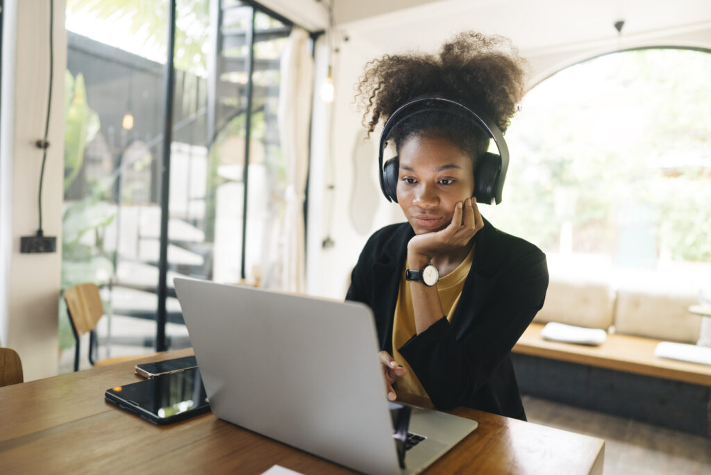 negative facial expression Young adult businesswoman mixed-race American  a bit exhausted after a Long video call and remote working  conference with team diverse colleagues,