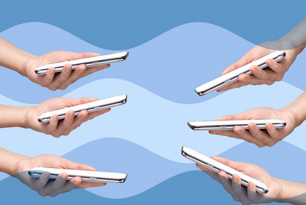 Six woman’s hands holding smart phones