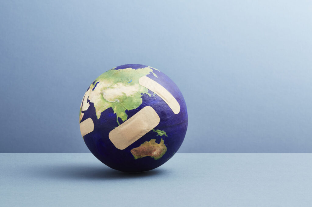 A world globe with band-aids