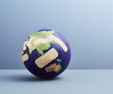A world globe with band-aids