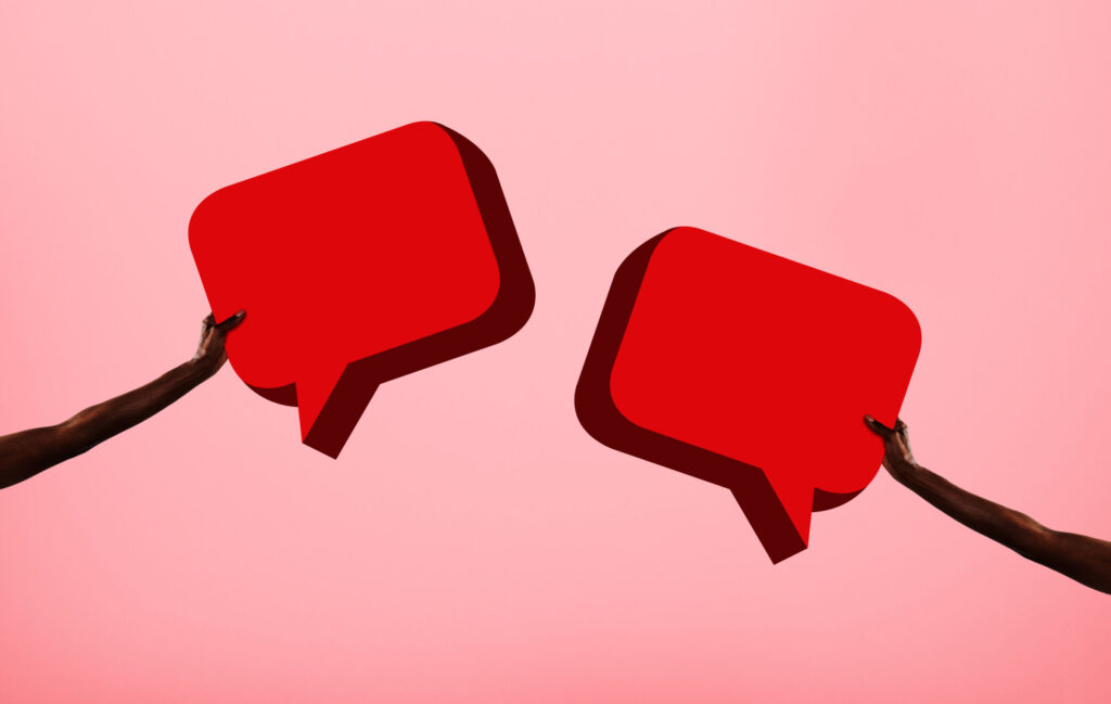 Arms-holding-two-speech-bubbles