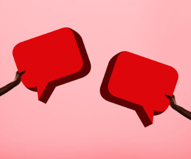 Arms-holding-two-speech-bubbles