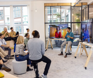 Business-people-having-hybrid-meeting-in-office