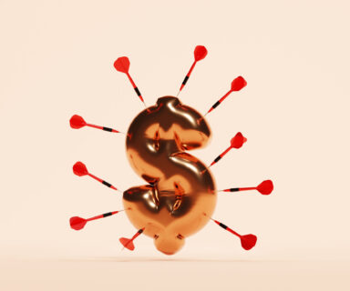 Dollar sign balloon surrounded by darts