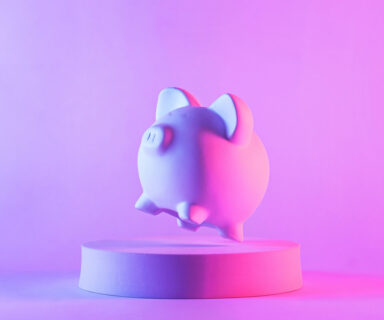 Studio-close-up-of-piggy-bank-floating-above-a-round-podium