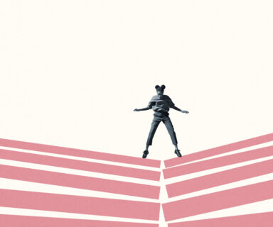 Woman jumping on broken pink block stacks
