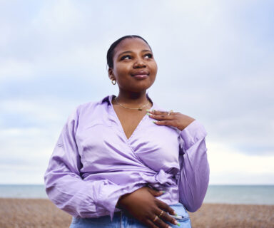 Woman-standing-confidently-alone-at-the-beach