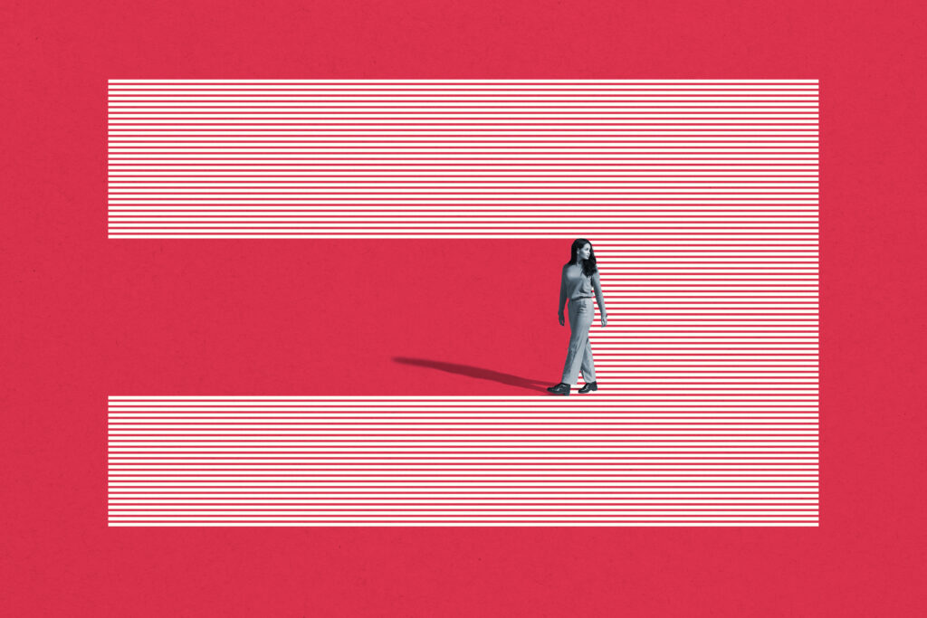 Young woman walking on striped studio backdrop
