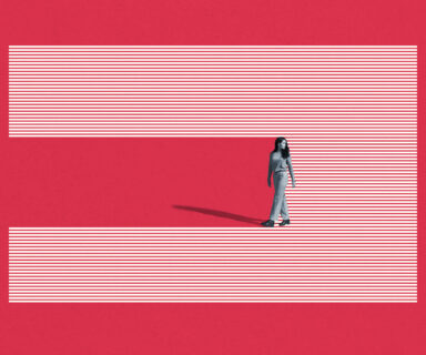 Young woman walking on striped studio backdrop