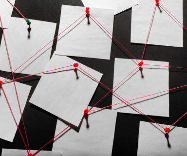 black-detecftive-board-with-blank-paper-linked-by-red-thread.