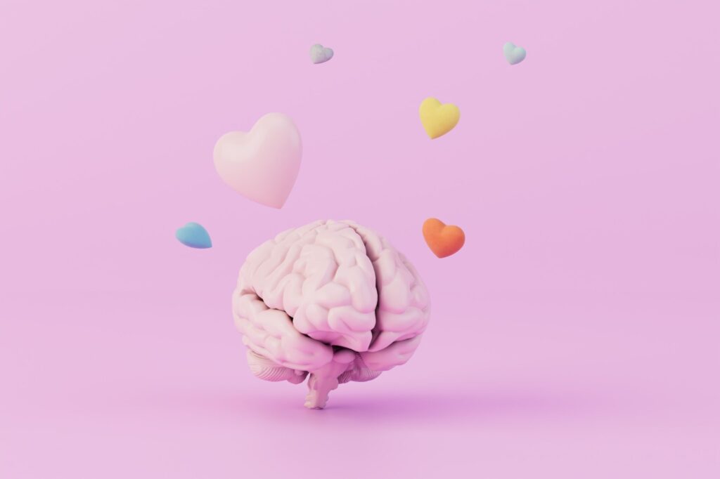 the concept of falling in love. the brain over which multi-colored hearts fly on a pastel background. 3D render
